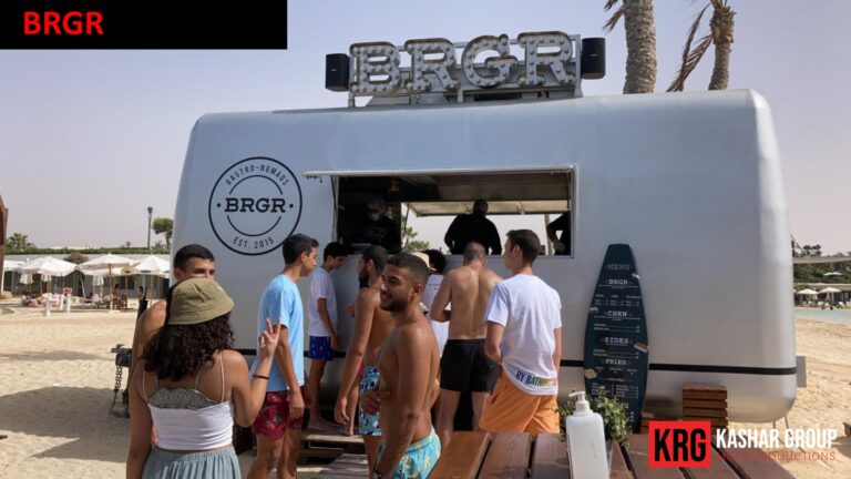 Mobile Solutions BRGR food trailer on a beach with people ordering food