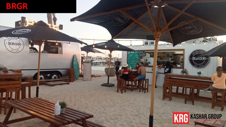 Mobile Solutions BRGR food trailer and outdoor dining area on a sandy beach