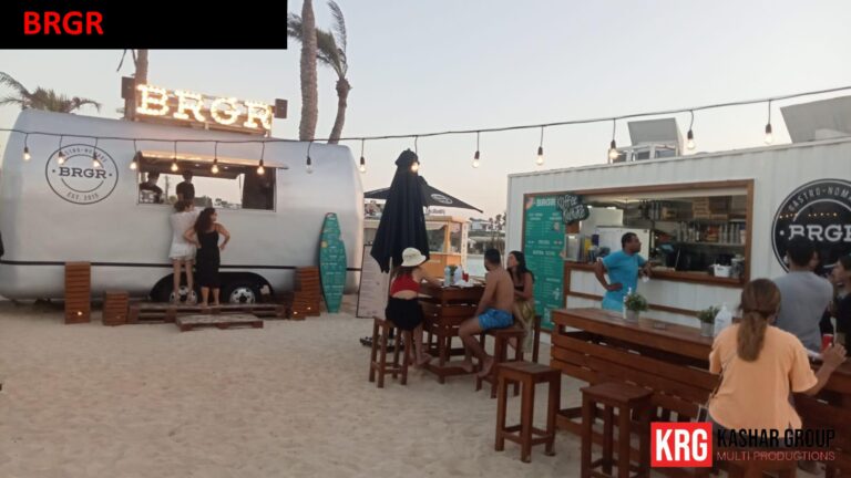 Mobile Solutions Food trailer "BRGR" serving food on a sandy beach with people enjoying meals
