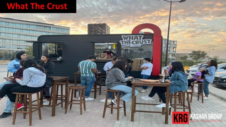 Mobile Solutions What The Crust food trailer with people dining outdoors at sunset