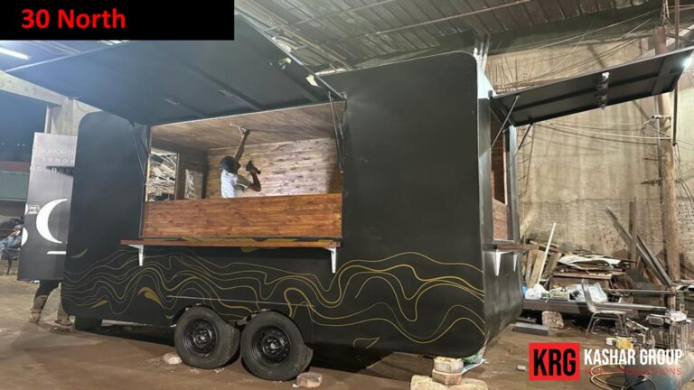 Mobile Solutions Custom food trailer construction with black exterior and gold wave design