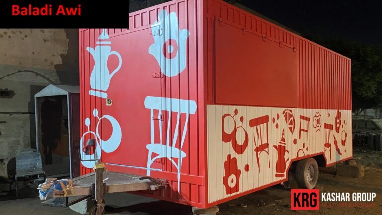 Mobile Solutions Red food trailer with white teapot and chair graphics, "Baladi Awi" text