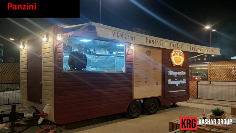 Mobile Solutions Panzini food trailer at night, with menu displayed and lights on