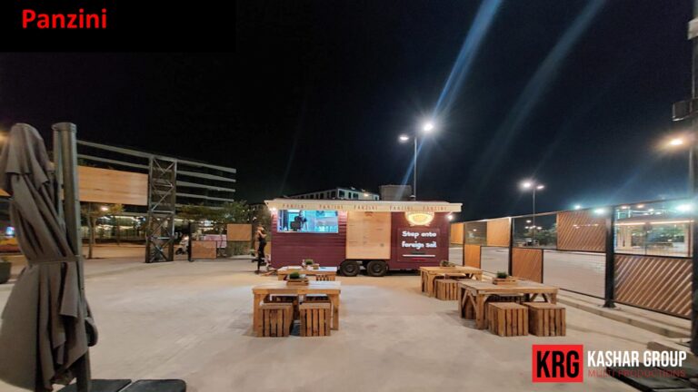 Mobile Solutions Panzini food trailer at night with outdoor seating