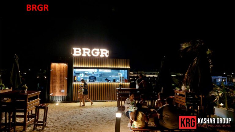 Mobile Solutions BRGR food container with outdoor seating on a sandy beach at night