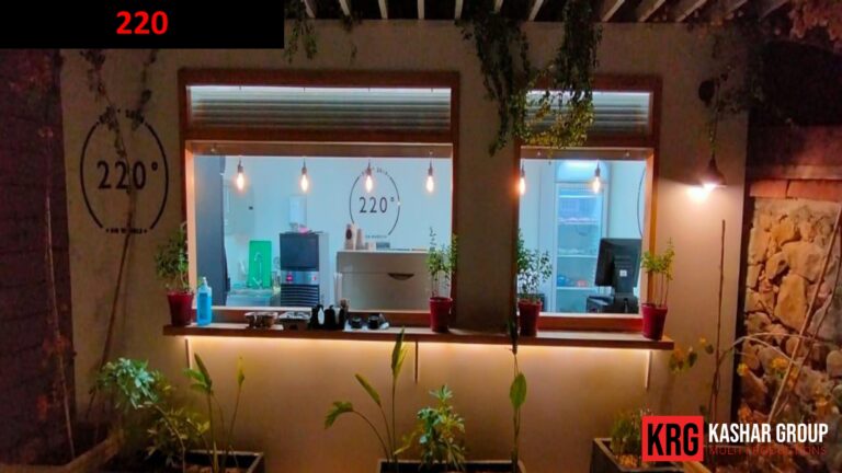 Mobile Solutions Cafe window with "220" logo and food containers, night view