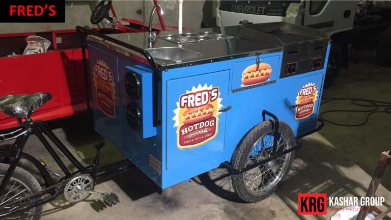 Mobile Solutions Fred's Hotdog food trailer with a red food cart in the background