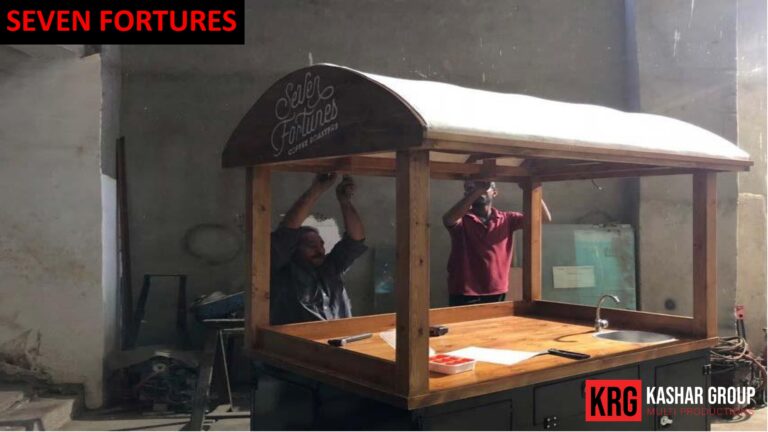 Mobile Solutions Two men assembling a custom food trailer with "Seven Fortunes" logo
