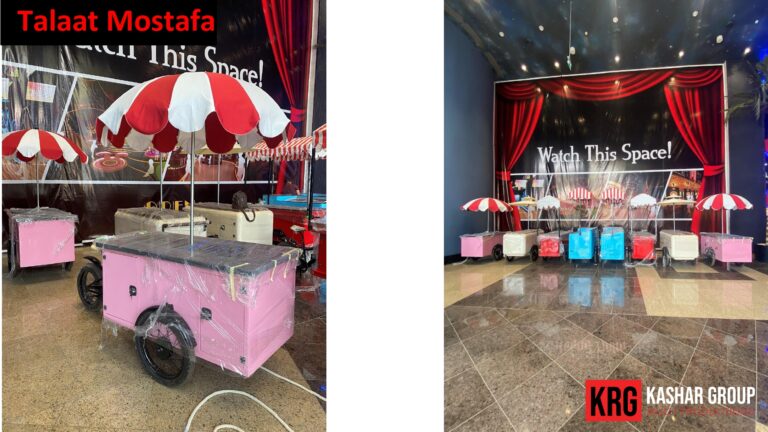 Mobile Solutions Pink food trailer with red and white umbrella and "Watch This Space!" sign