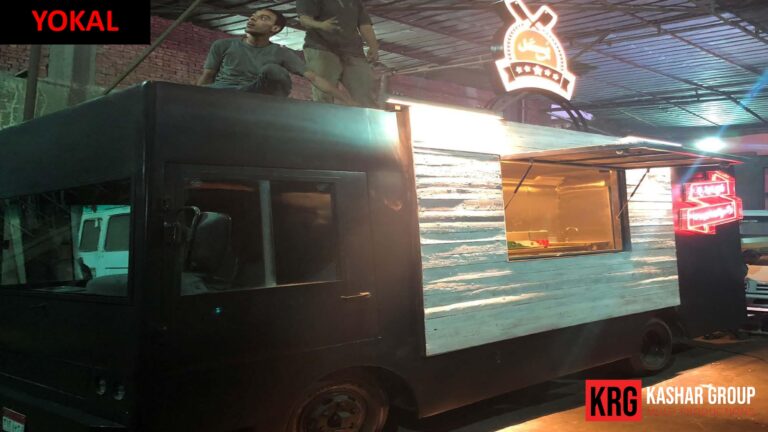 Mobile Solutions YOKAL food trailer with rustic wood siding, illuminated sign