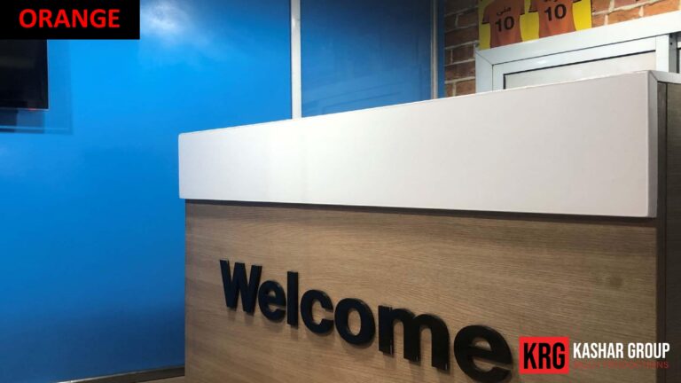 Mobile Solutions Reception desk with "Welcome" in large letters and "Orange" branding