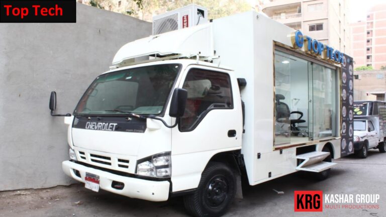 Mobile Solutions White Chevrolet advertising trailer with "Top Tech" branding and glass display