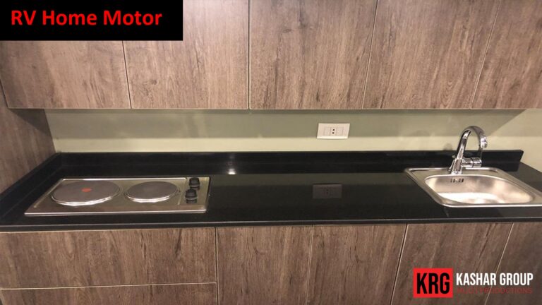 Mobile Solutions RV home motor kitchen with stovetop, sink, and wooden cabinets
