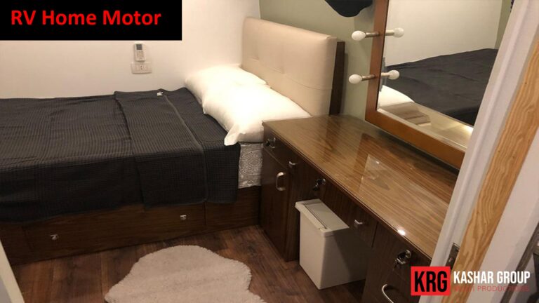 Mobile Solutions RV home motor interior with a bed, vanity, and mirror