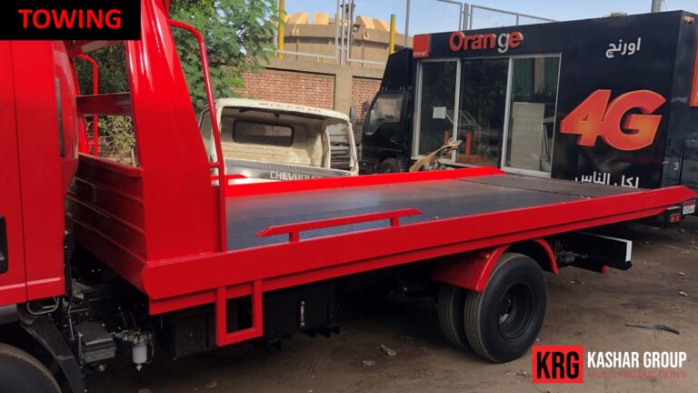 Mobile Solutions Red towing truck with "TOWING" text and KASHAR GROUP logo
